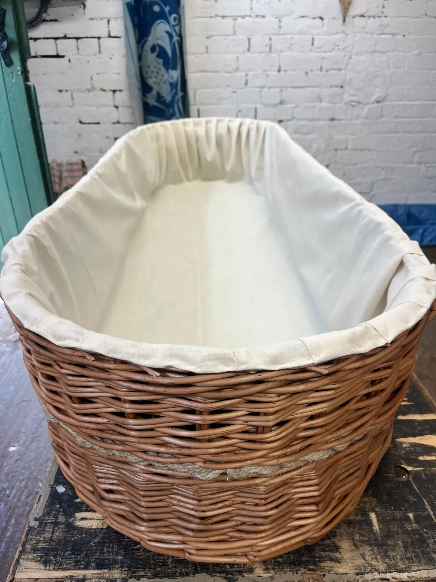 A willow coffin with its cotton liner fitted